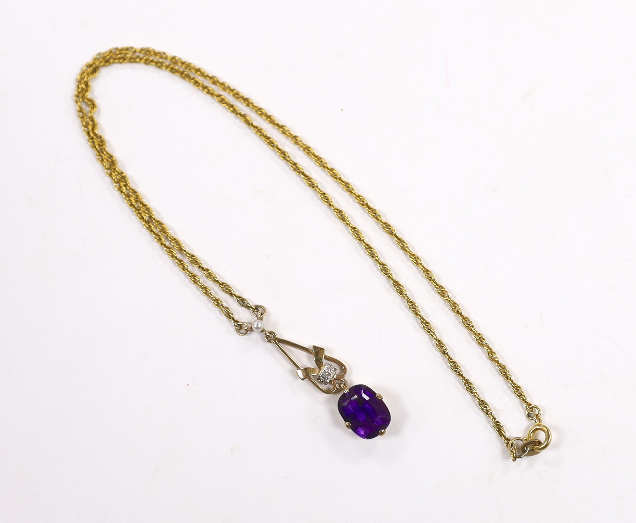 A 1960's 9ct gold, amethyst, seed pearl and diamond chip set drop pendant, 35mm, on a 9ct gold chain, 40cm and a yellow metal, amethyst and seed pearl set oval brooch, gross weight 16.5 grams.